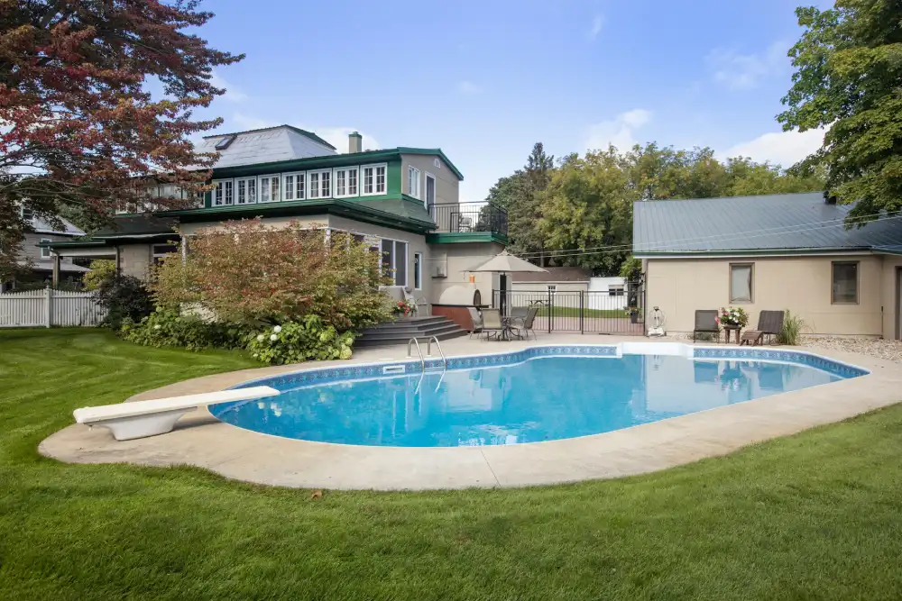backyard with a pool house and swimming pool